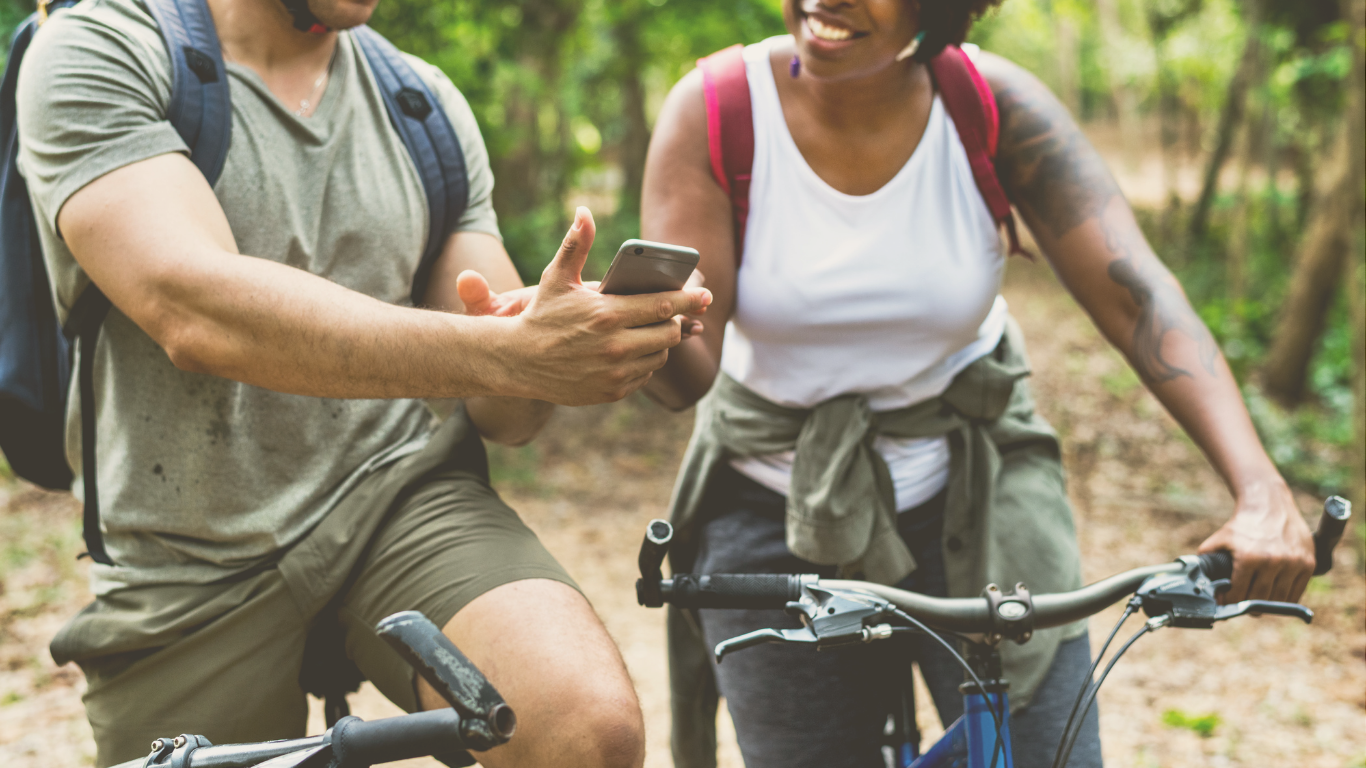 A group of friends cycling near their RV campsite, enjoying a casual RV trip filled with outdoor activities.